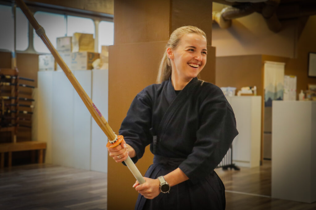 Smiling participants enjoying kendo experience in Tokyo