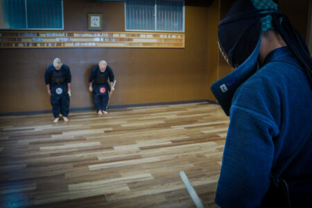 Kendo students bowing properly in a Japanese dojo in Tokyo