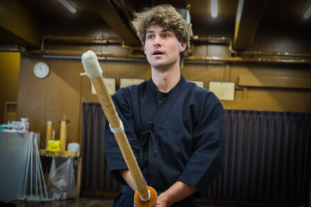 Kendo training moment with focused expression in Tokyo dojo