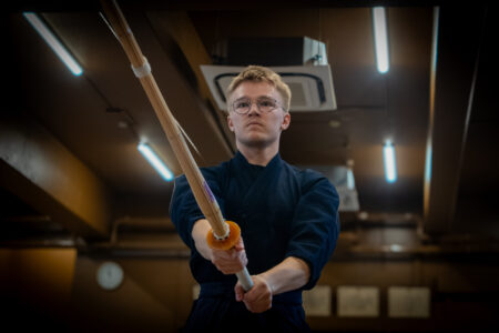 Focused kendo learner practicing techniques in Tokyo