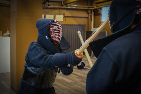 Participants wearing kendo armor during a sparring match in Tokyo