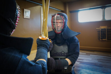 Intense kendo sparring session in Tokyo with players wearing men and armor